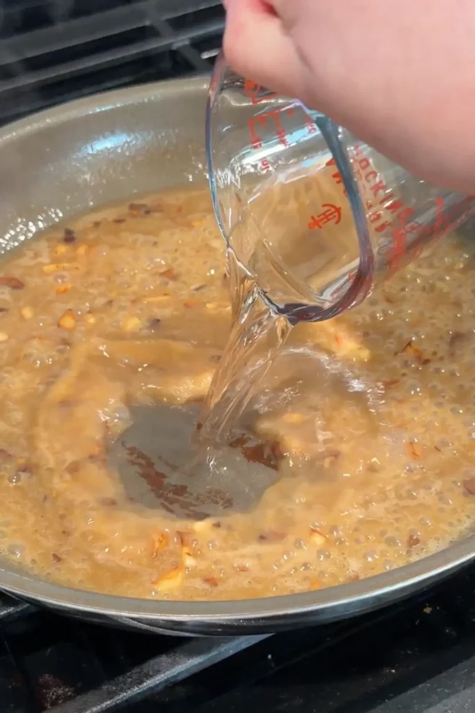 White wine added to the simmering lemon garlic piccata sauce.