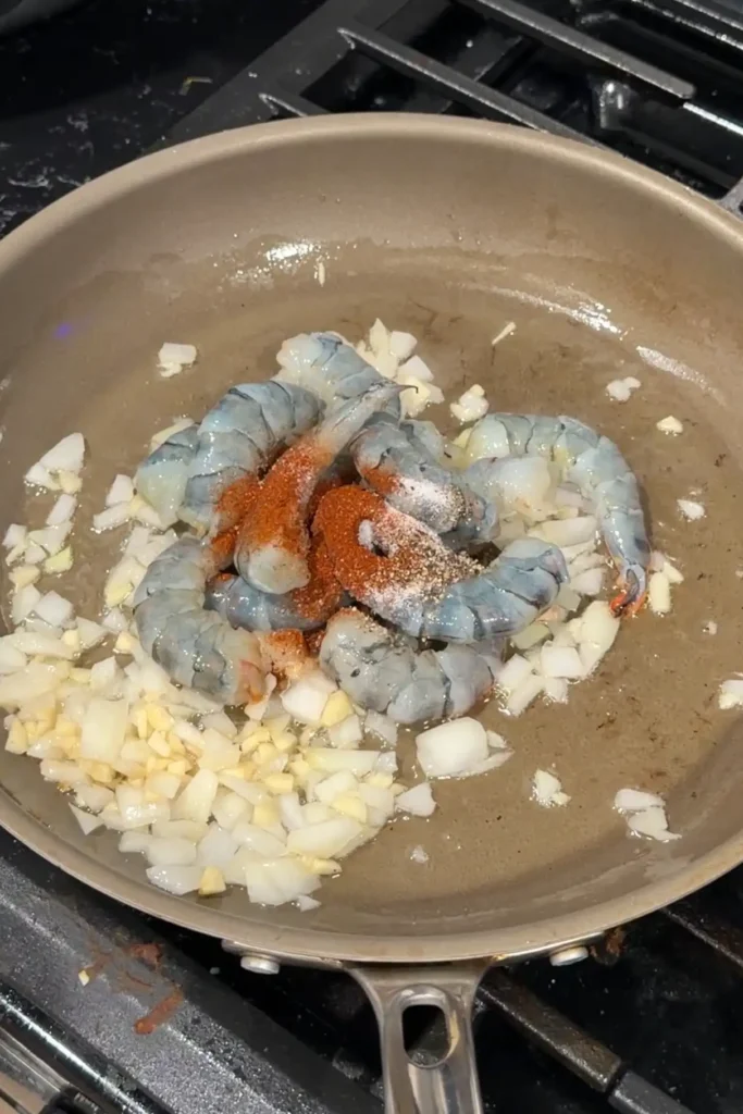 Raw shrimp added to sautéed onion and garlic and seasoned with salt, pepper, and paprika.