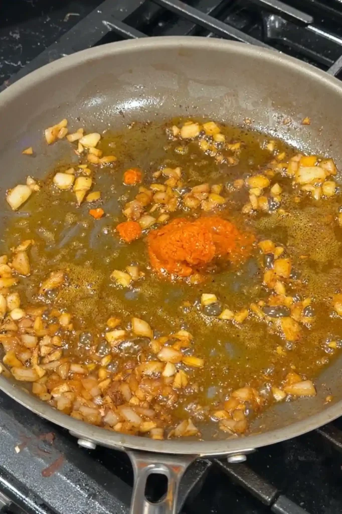 Aligue crab paste added to the skillet after removing the cooked shrimp.