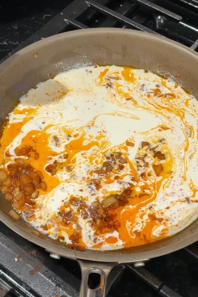 Heavy cream added to the sautéed aligue to make the creamy crab paste sauce.