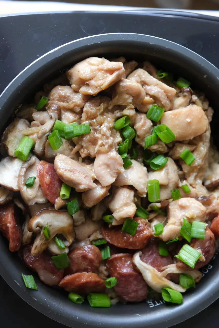 Rice cooker claypot chicken rice with chicken thighs, Chinese sausage, shiitake mushrooms, and green onions.