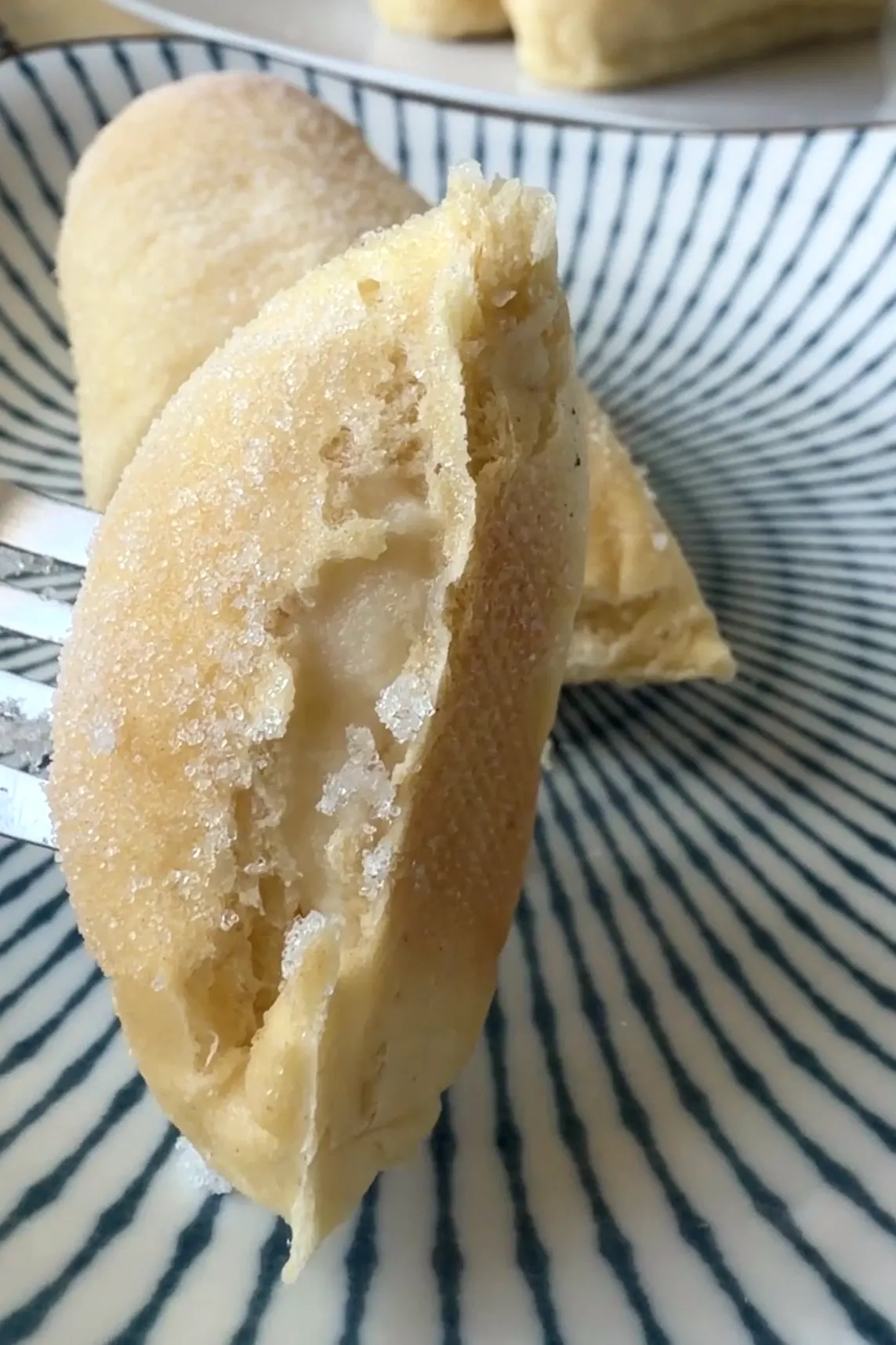 Close-up of a Filipino cheese roll showing the soft bread and cheese filling inside.