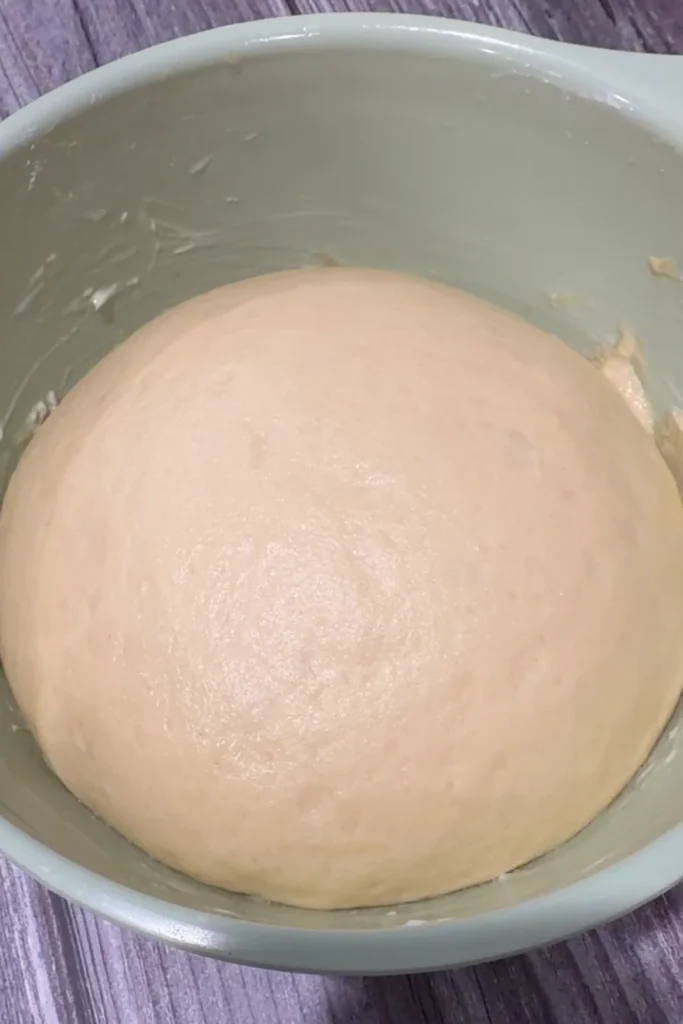 Risen cheese roll dough after the first proof.