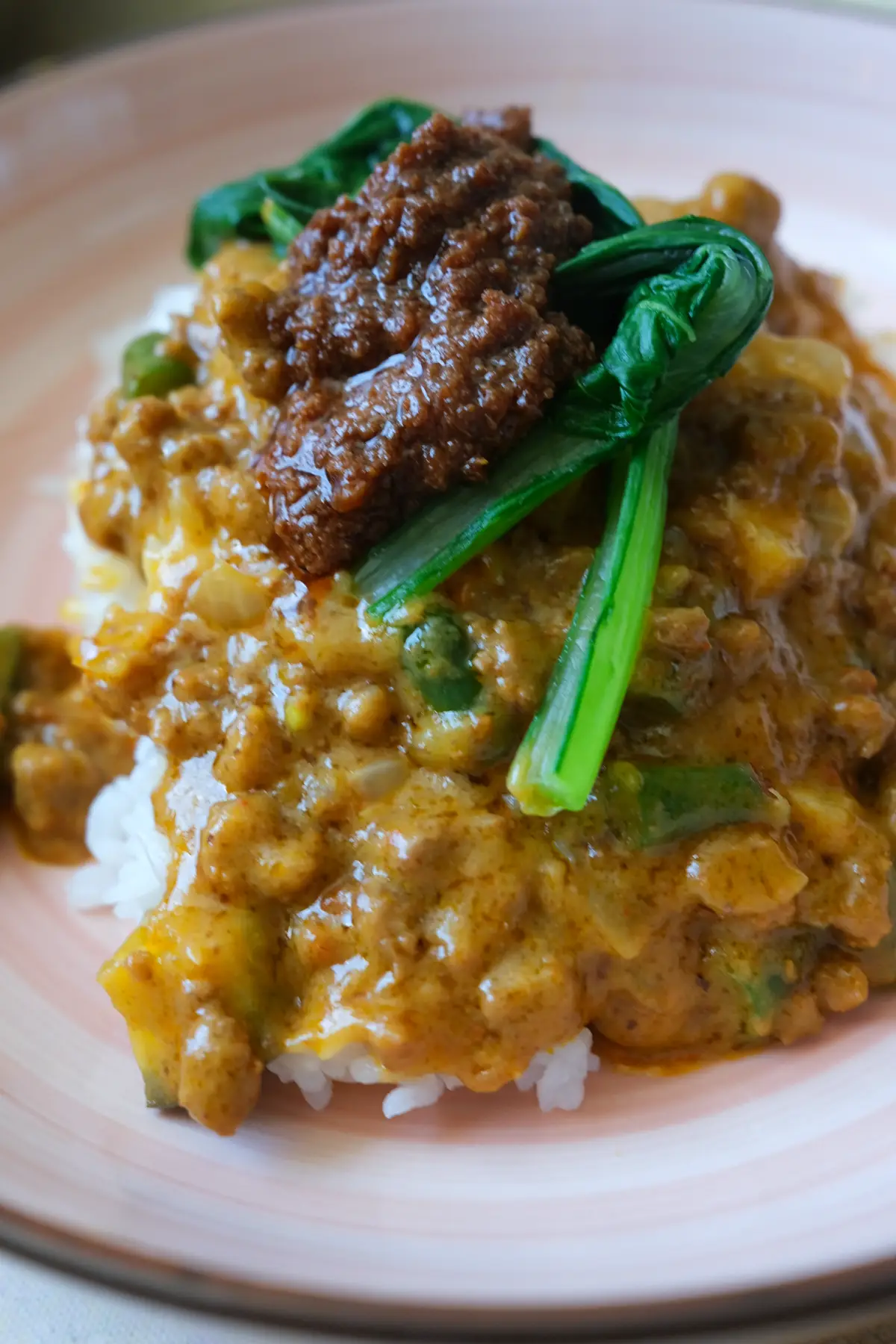 Easy ground beef kare kare with eggplant and long beans served over steamed white rice.