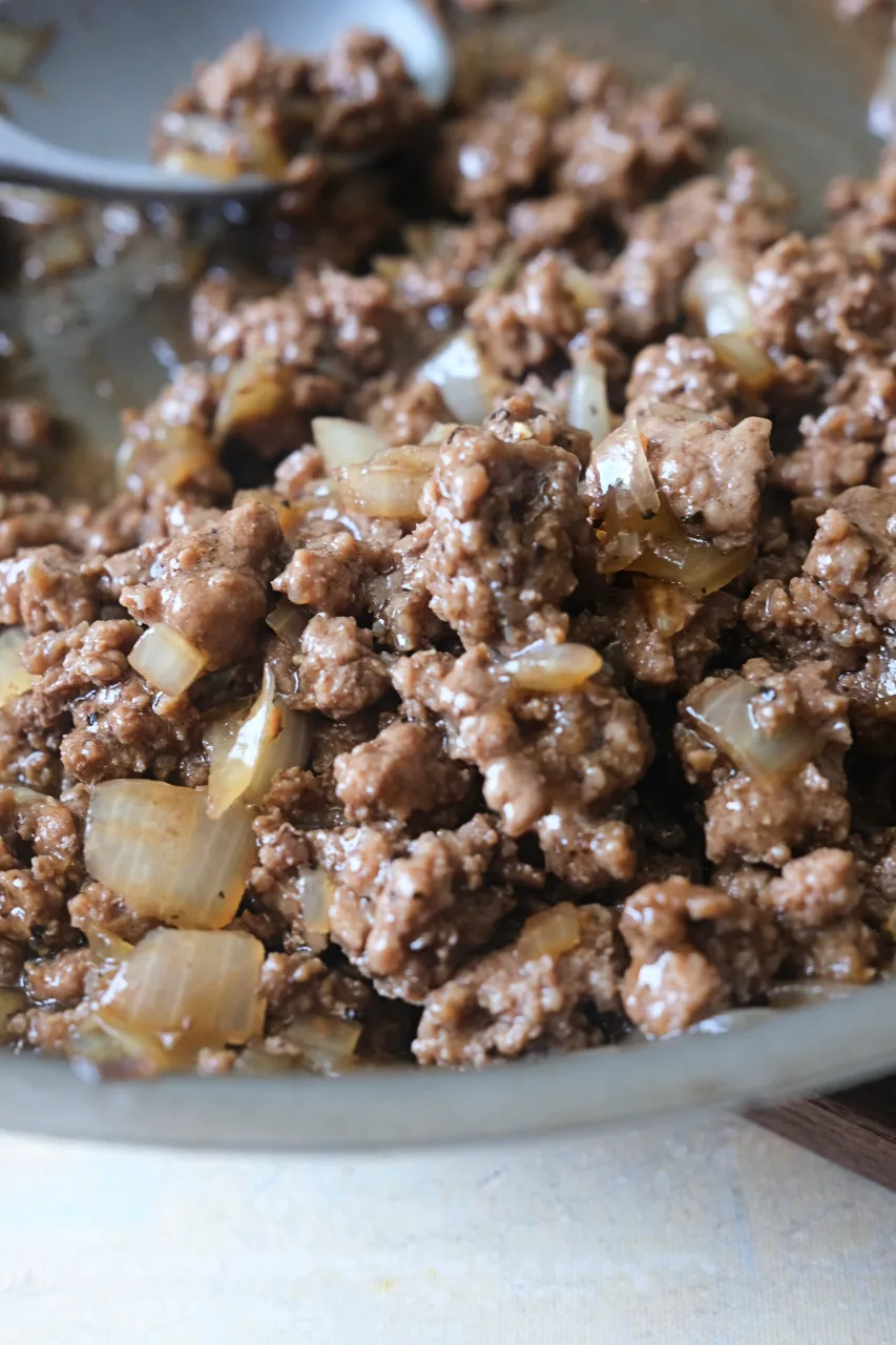 Close-up of saucy honey ground beef and onions in a skillet.
