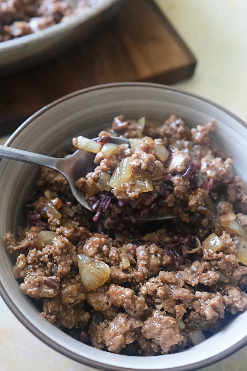 Honey ground beef served over a bowl of mixed with black rice.