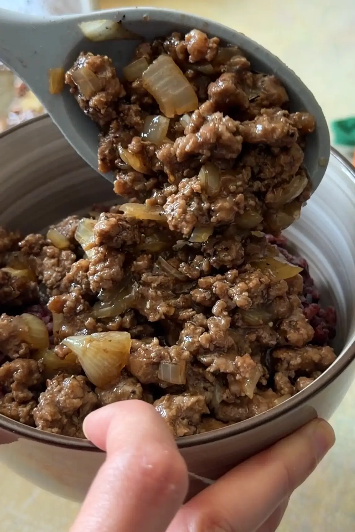 Jollibee-style honey ground beef being spooned over rice.