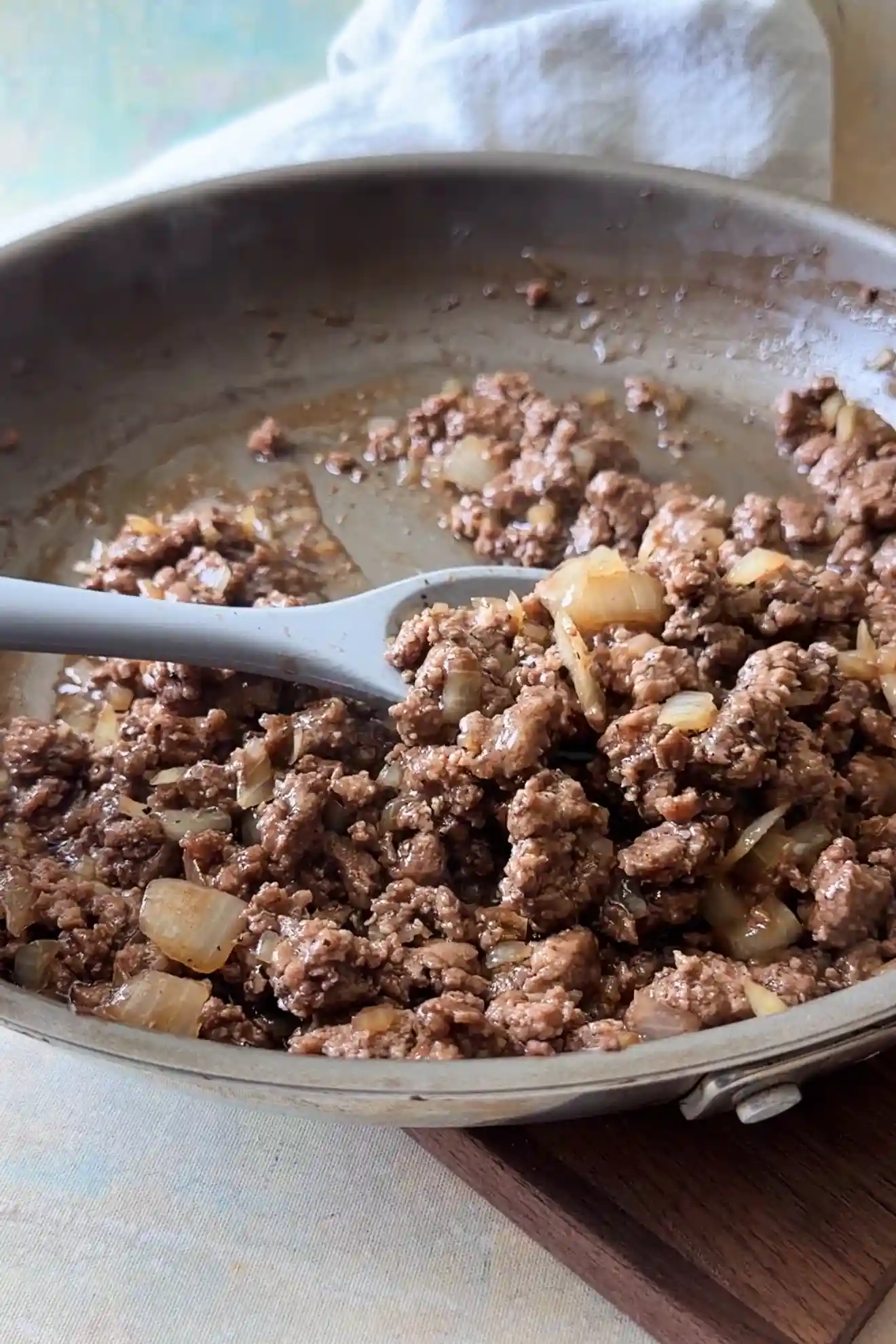 Honey ground beef with onions in a skillet, ready to serve.