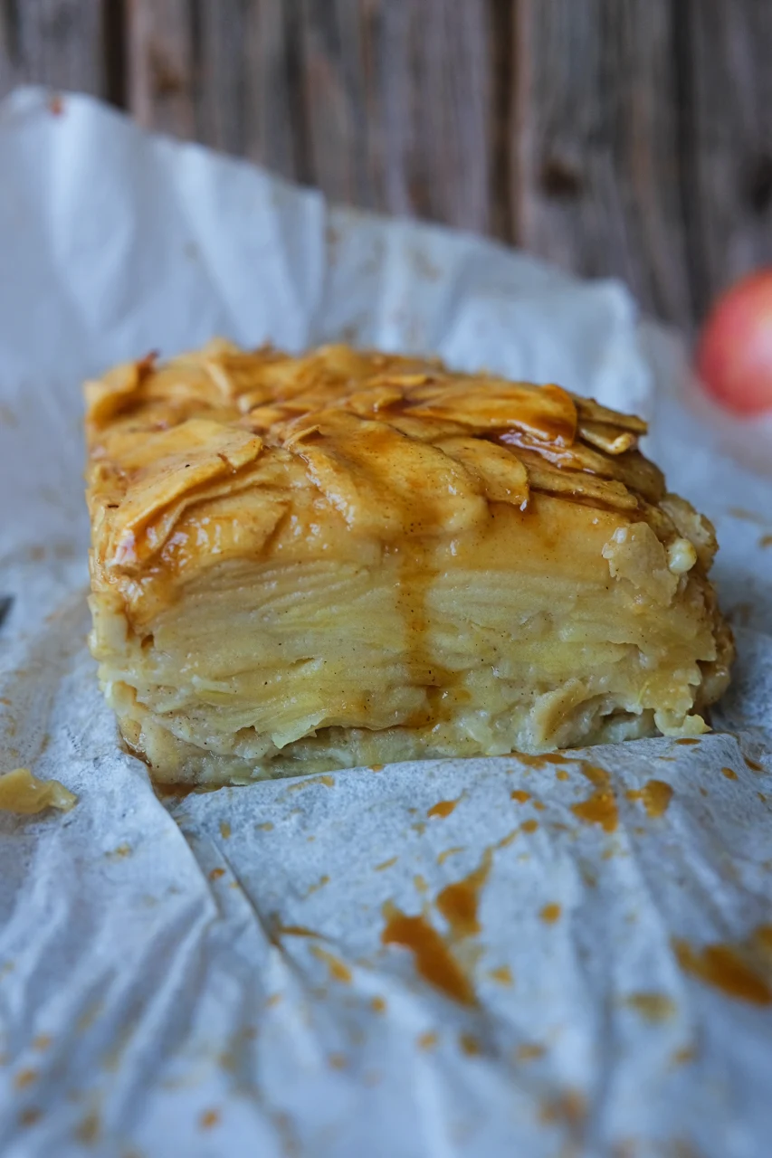 Close-up of invisible apple cake showing dozens of thin apple layers topped with caramel.