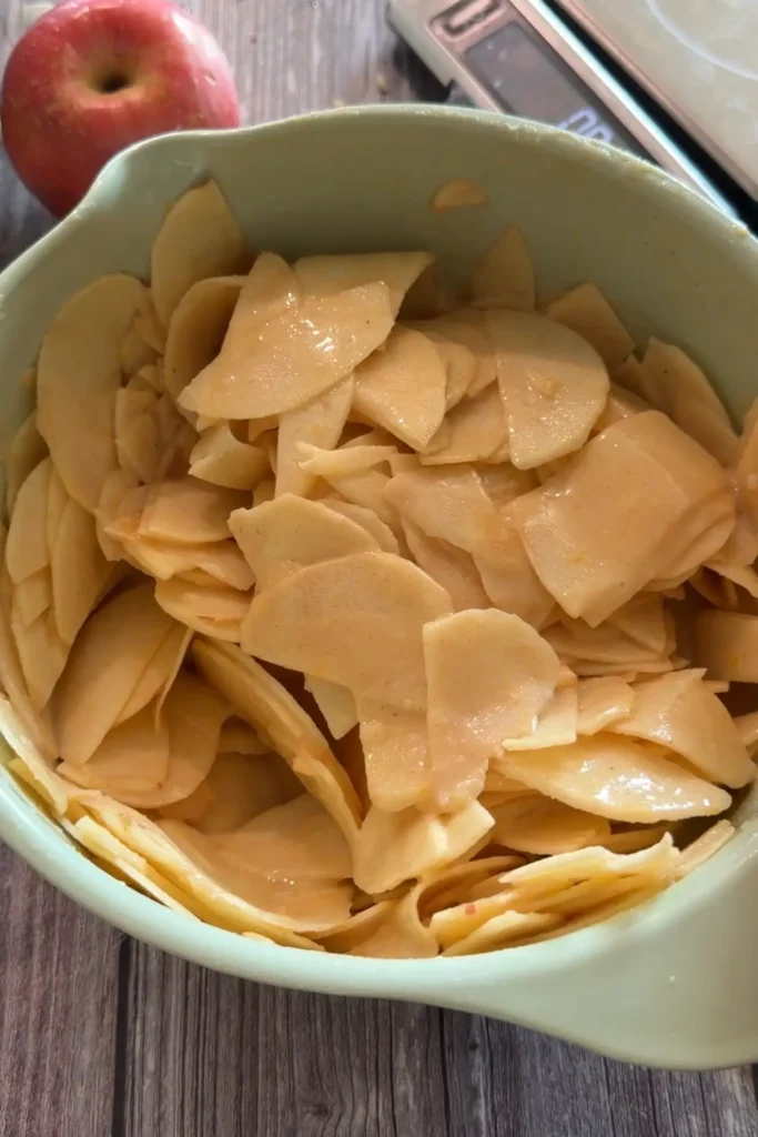 Thin apple slices evenly coated in the spiced cake batter.