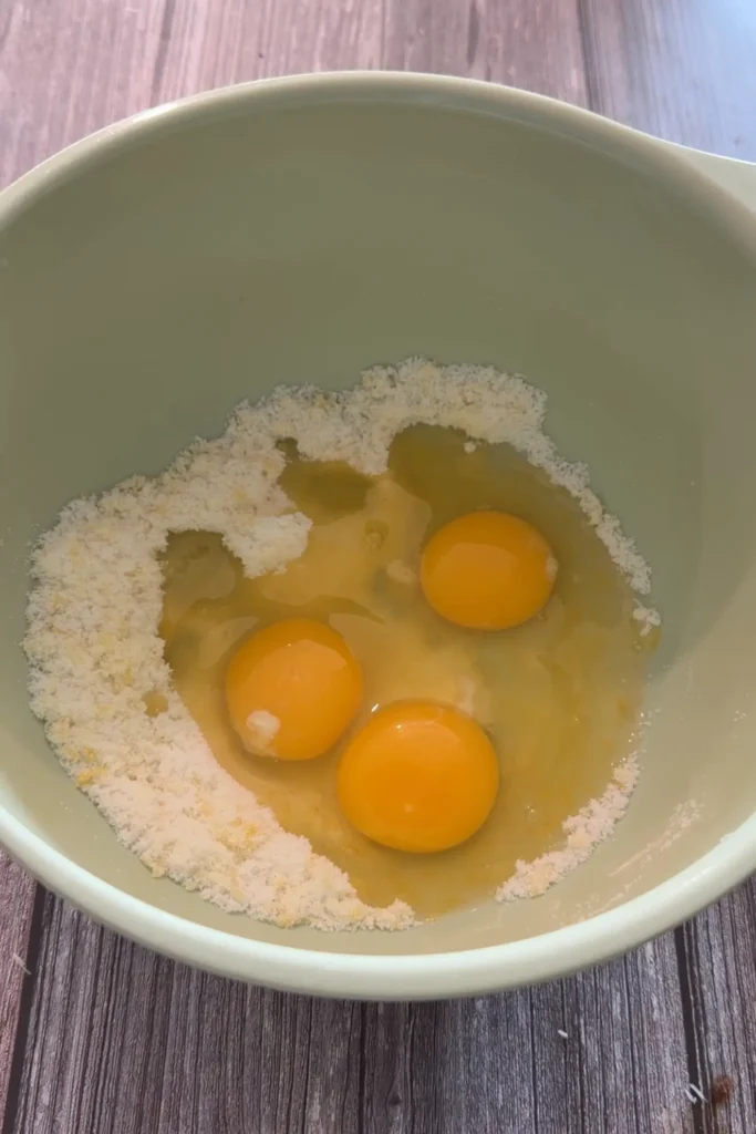 Three eggs added to the lemon sugar mixture for invisible apple cake.