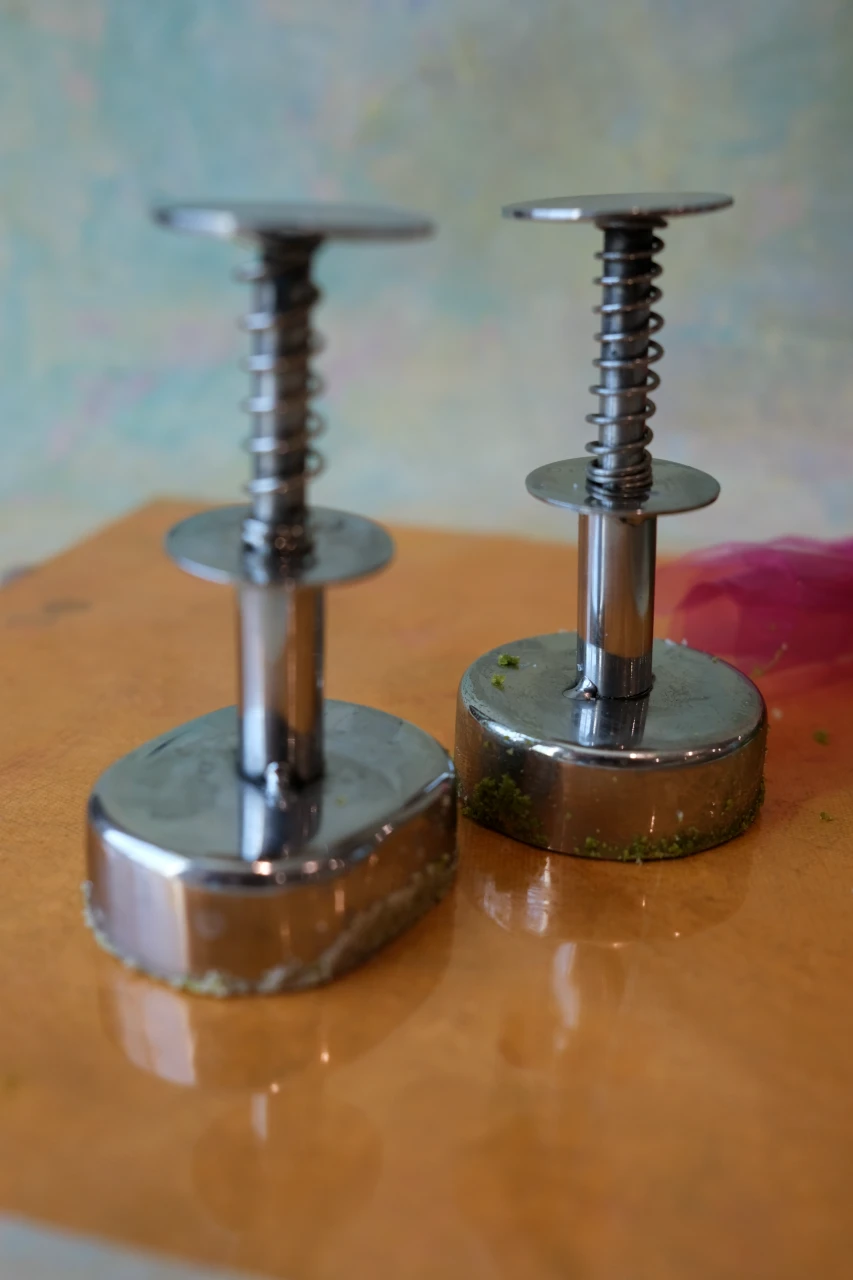 Round and oval metal polvoron molders used to shape homemade Filipino polvoron.