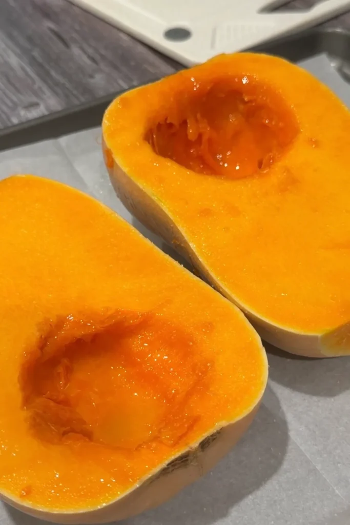 Fresh butternut squash cut in half with the seeds removed before roasting.