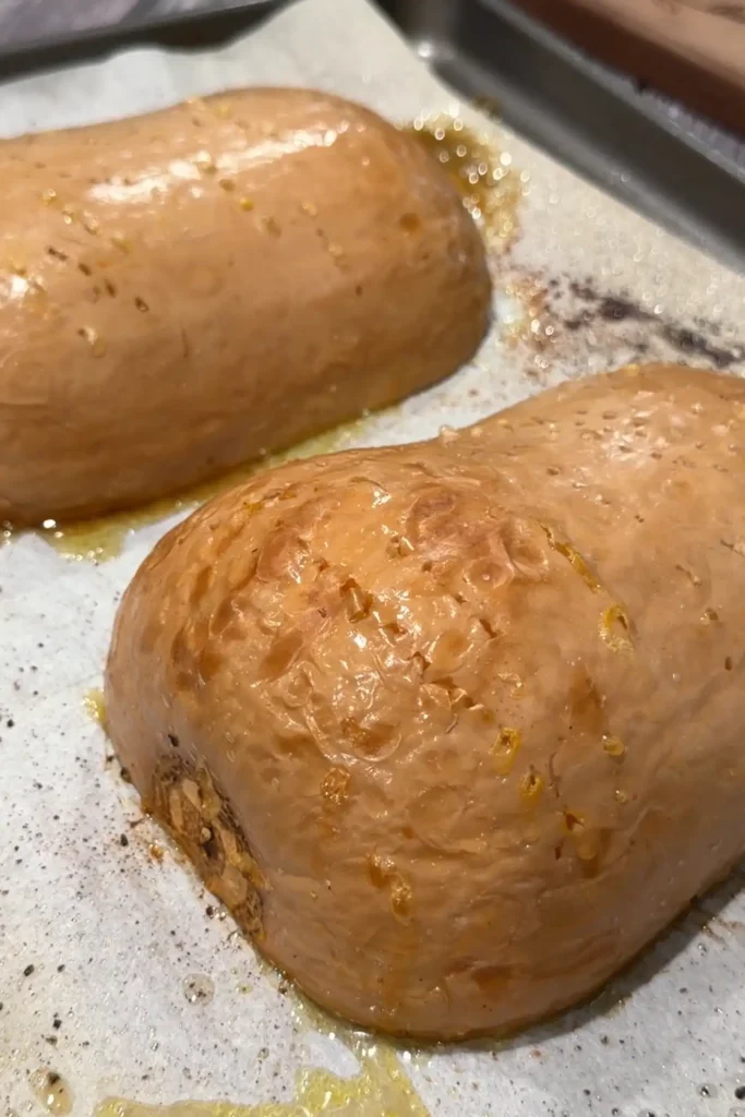 Oven roasted butternut squash halves flipped cut-side up after roasting until tender.