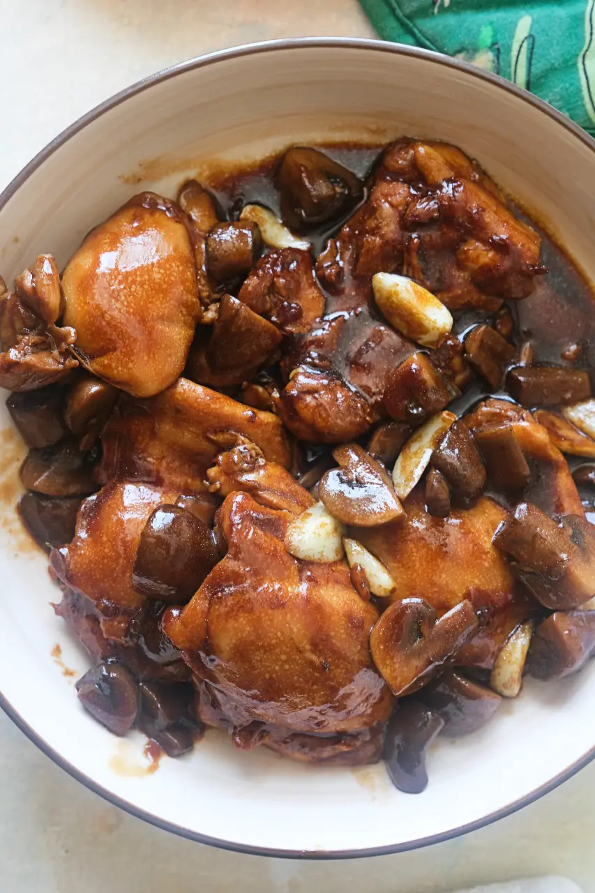 Skillet chicken thighs with mushrooms and garlic covered in rich brown gravy.