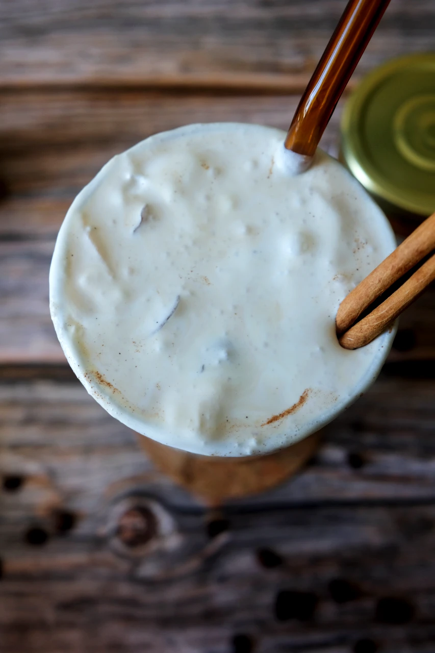 Overhead view of an iced pumpkin spice latte topped with thick salted caramel cream and cinnamon.