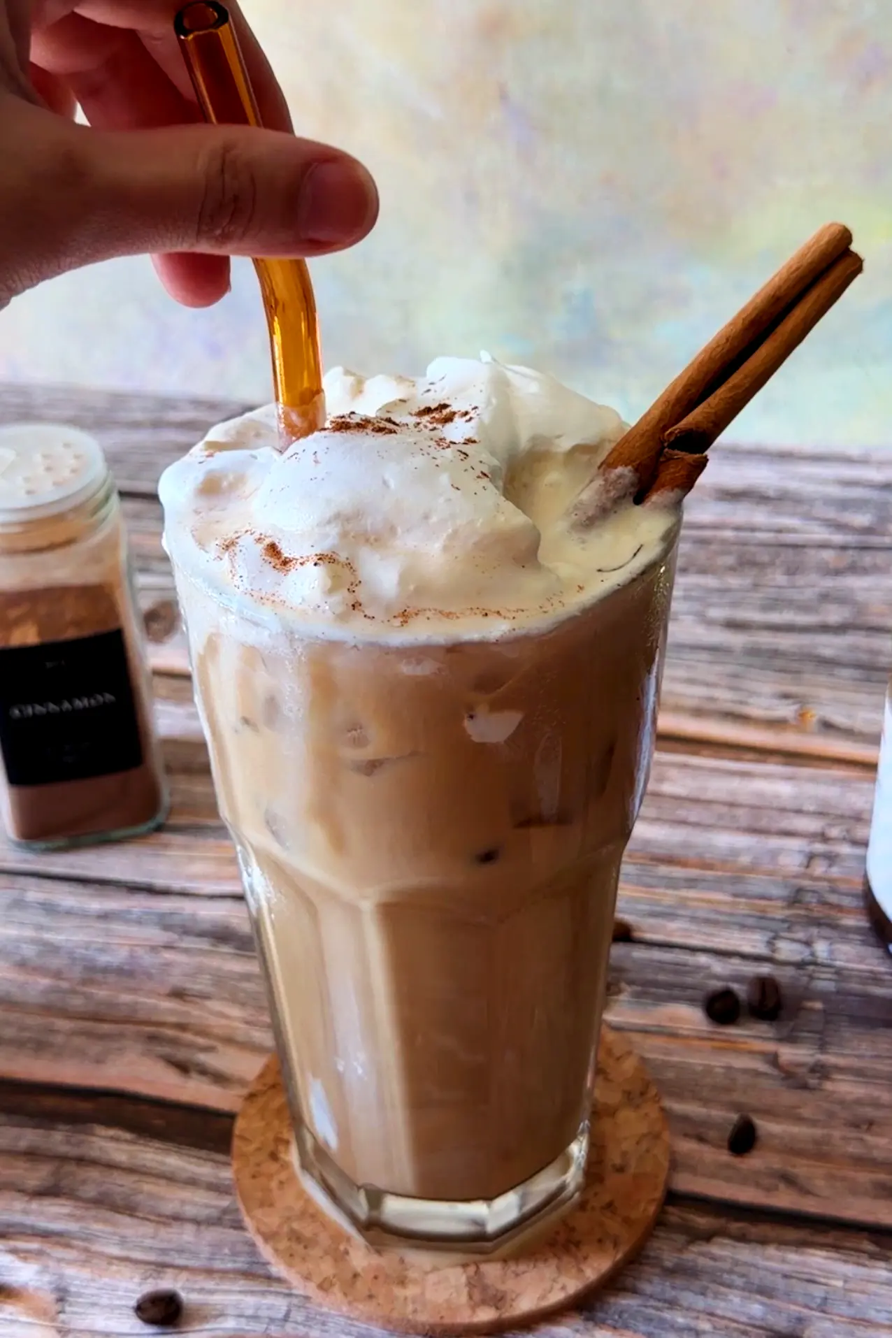 Starbucks copycat iced pumpkin spice latte with salted caramel cream, cinnamon, and a cinnamon stick.