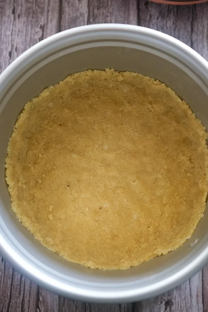 Almond flour crust in a springform cake pan