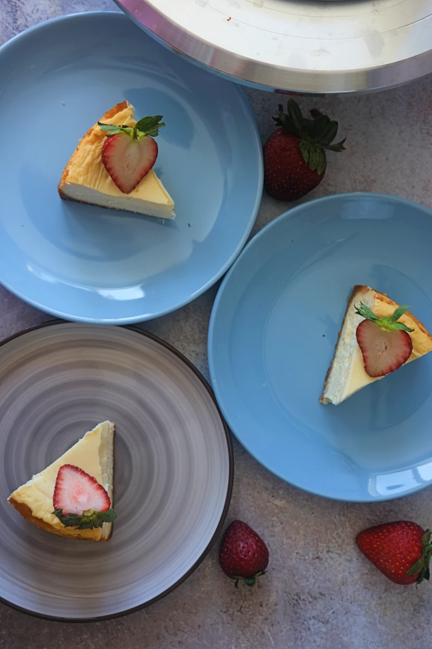 Overhead shot of keto cheesecake slices topped with sliced strawberries