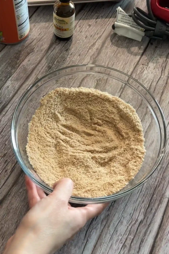 Combined almond flour, baking powder, pumpkin pie spice, cinnamon, and salt in a glass bowl.