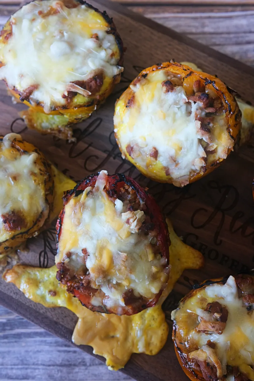 Overhead view of roasted stuffed bell peppers filled with ground turkey, eggs, and melted cheese.